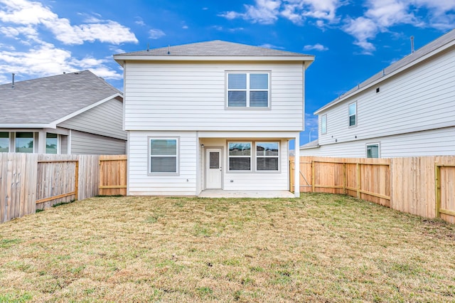 rear view of property with a yard and a patio