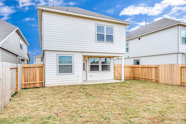 rear view of property with a patio and a lawn