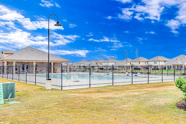 view of swimming pool with a yard