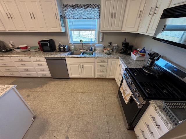 kitchen with stainless steel appliances, white cabinetry, sink, and light stone counters