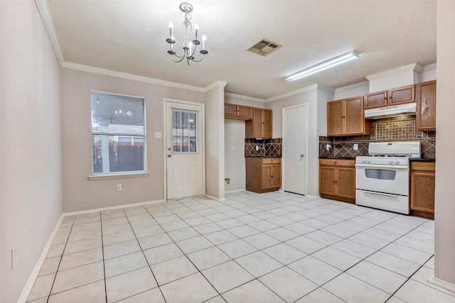 kitchen with ornamental molding, white gas range, a chandelier, and decorative backsplash