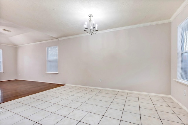 unfurnished room featuring ornamental molding, a healthy amount of sunlight, and a chandelier