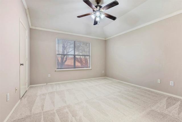 carpeted empty room featuring lofted ceiling, ornamental molding, and ceiling fan