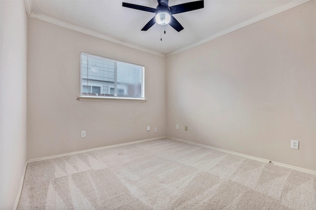 spare room featuring crown molding, light colored carpet, and ceiling fan