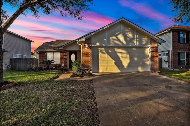 view of front of property with a garage and a lawn