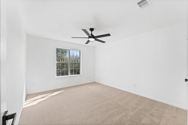 unfurnished room featuring light colored carpet and ceiling fan