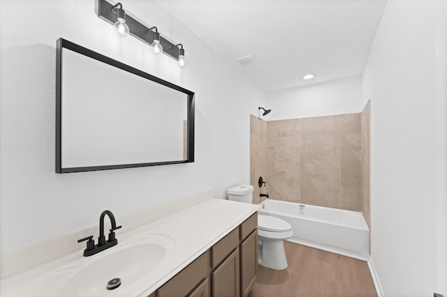 full bathroom with vanity, hardwood / wood-style flooring, tub / shower combination, and toilet