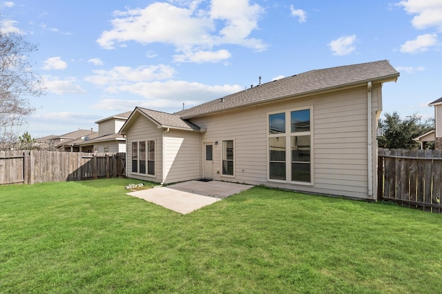 rear view of property featuring a patio and a lawn