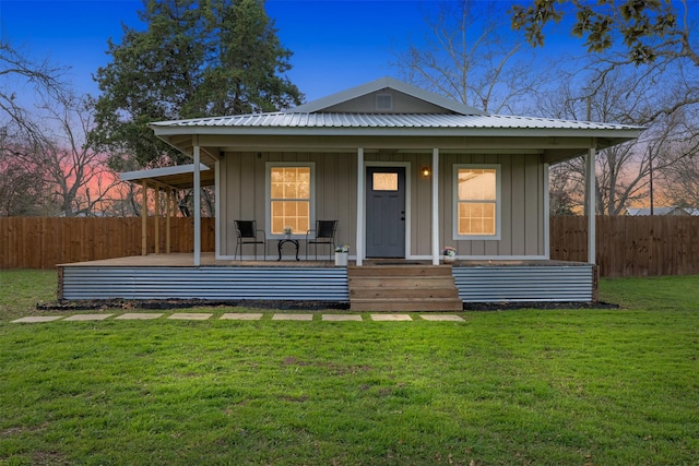 bungalow-style home with a yard, an outdoor structure, and covered porch