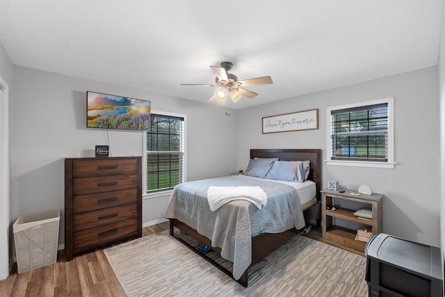 bedroom with hardwood / wood-style floors and ceiling fan