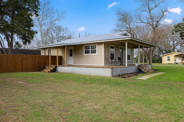 back of property featuring a lawn and a porch