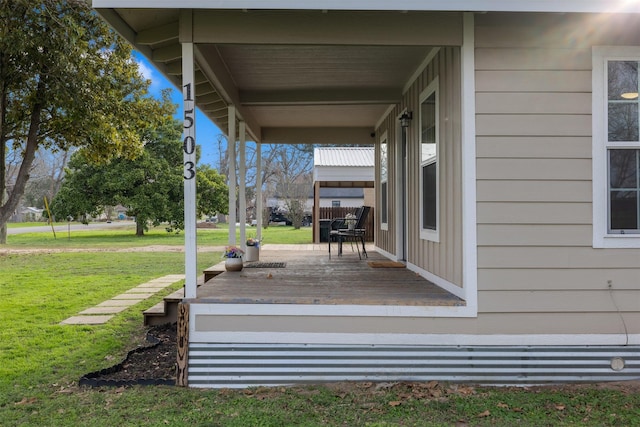 wooden deck with a lawn