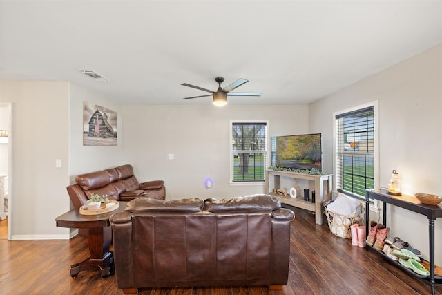 living room featuring ceiling fan and dark hardwood / wood-style floors