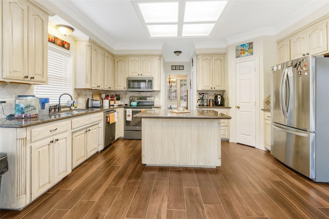 125 Indian Warrior Trl, Lake Jackson, TX 77566 - kitchen with sink, stainless steel appliances, a center island, decorative backsplash, and dark stone counters