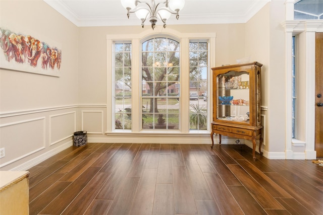 125 Indian Warrior Trl, Lake Jackson, TX 77566 - unfurnished dining area with dark hardwood / wood-style flooring, crown molding, decorative columns, and an inviting chandelier