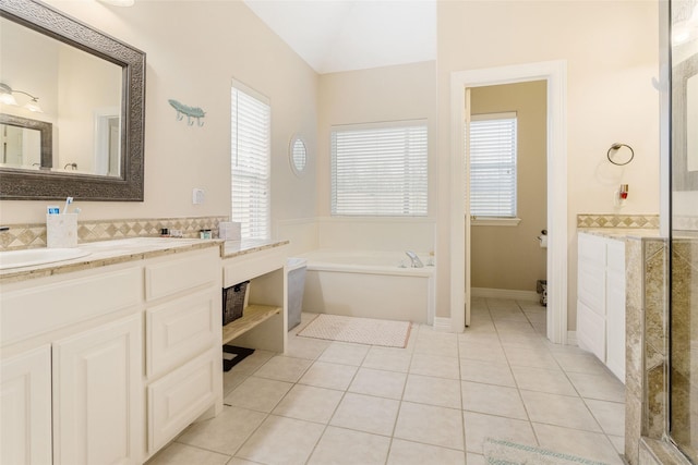 125 Indian Warrior Trl, Lake Jackson, TX 77566 - bathroom featuring vanity, a tub, a healthy amount of sunlight, and tile patterned floors
