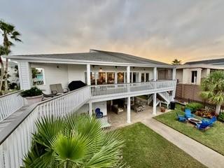 back of property with a yard and a patio area