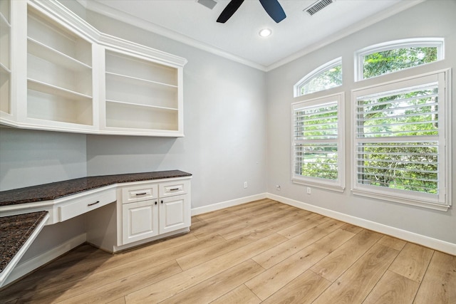 interior space featuring built in desk, ornamental molding, light hardwood / wood-style floors, and ceiling fan