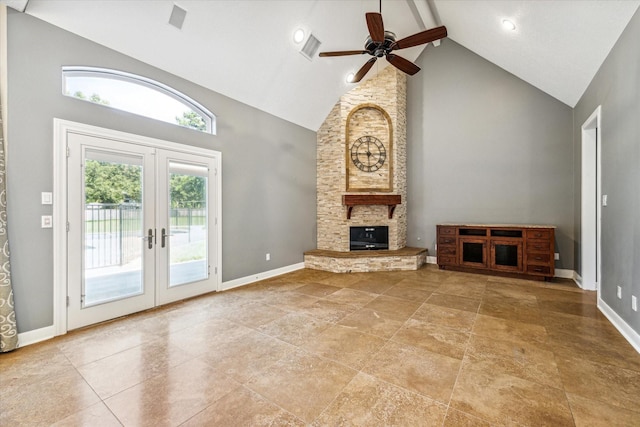 unfurnished living room with french doors, a stone fireplace, high vaulted ceiling, and beamed ceiling