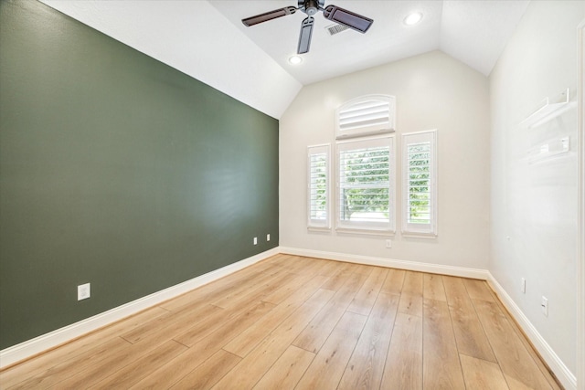 empty room featuring ceiling fan, lofted ceiling, and light hardwood / wood-style floors