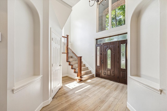 entrance foyer with light hardwood / wood-style floors and a high ceiling