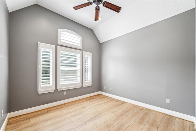 spare room featuring ceiling fan, lofted ceiling, and light hardwood / wood-style floors