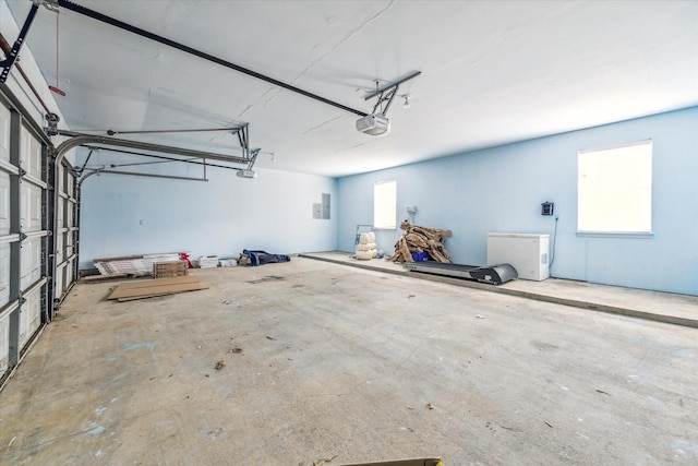 garage with a garage door opener and electric panel