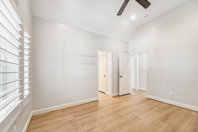 spare room featuring ceiling fan, vaulted ceiling, and light wood-type flooring