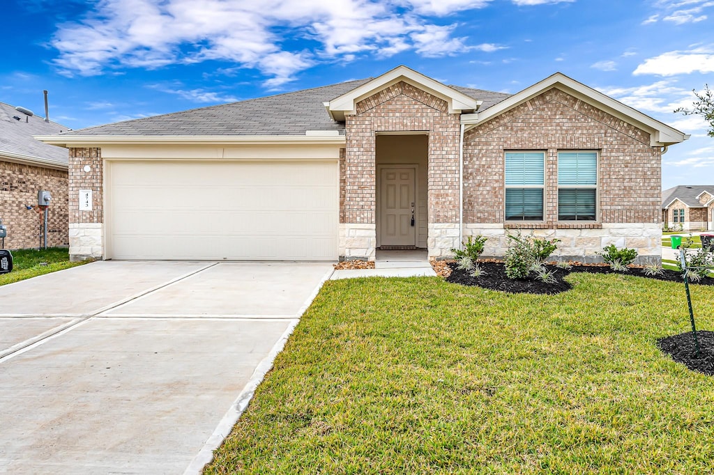 ranch-style house featuring a garage and a front yard