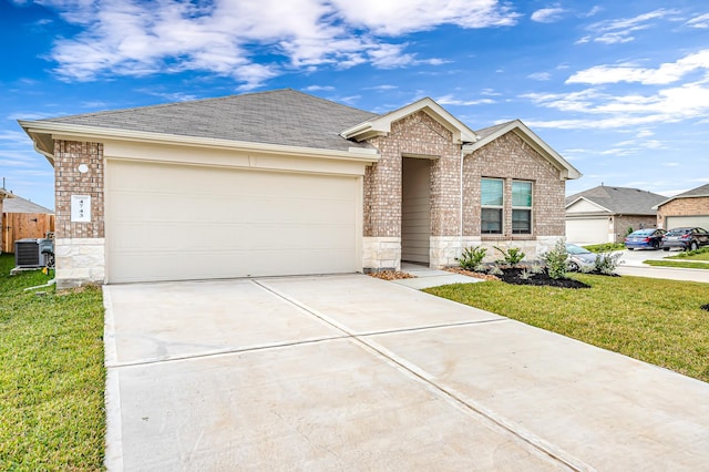 ranch-style home featuring a garage, central AC unit, and a front yard