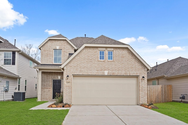 view of front of house featuring central AC, a garage, and a front yard