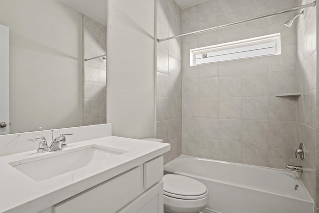 full bathroom with vanity, toilet, and tiled shower / bath combo