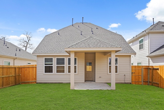 rear view of property featuring a lawn and a patio