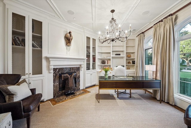 office space with a fireplace, ornamental molding, coffered ceiling, and a chandelier