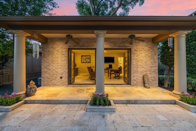 exterior entry at dusk with ceiling fan and a patio