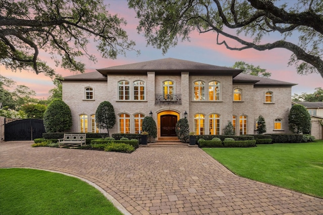 view of front facade featuring french doors and a lawn