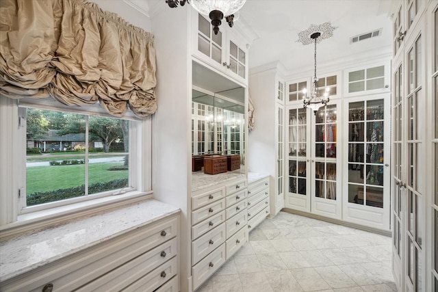 walk in closet featuring a notable chandelier