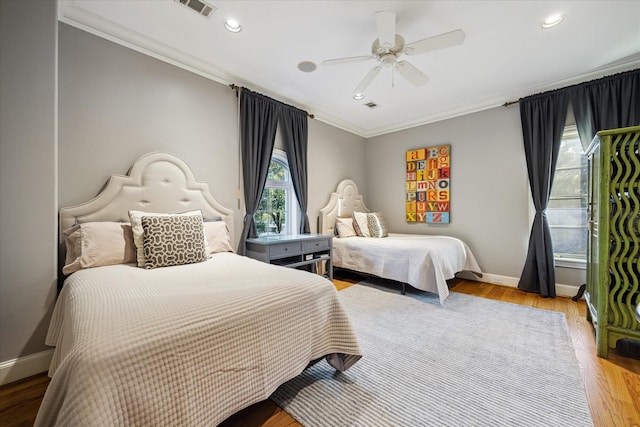 bedroom featuring ornamental molding, ceiling fan, and light wood-type flooring