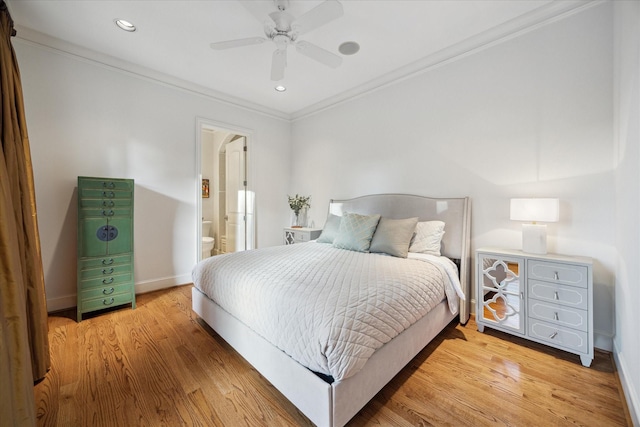 bedroom featuring wood-type flooring, connected bathroom, ceiling fan, and crown molding