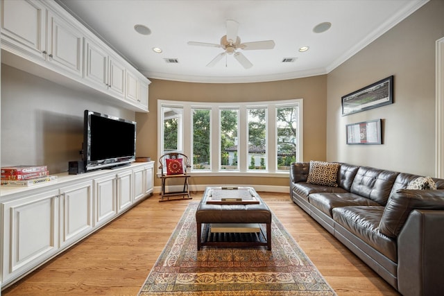 living room with ceiling fan, ornamental molding, and light hardwood / wood-style floors