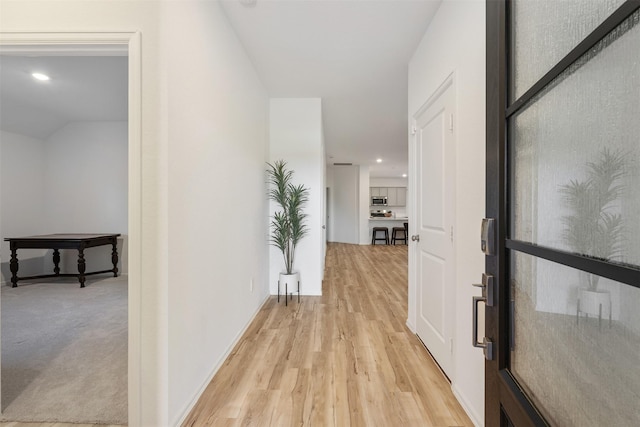 corridor with light wood-type flooring