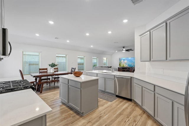 kitchen featuring gray cabinetry, light hardwood / wood-style flooring, stainless steel appliances, and a kitchen island