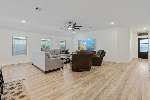 living room featuring light hardwood / wood-style flooring, ceiling fan, and vaulted ceiling