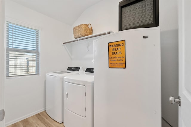 washroom featuring washer and clothes dryer and light hardwood / wood-style floors