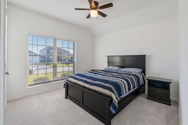 bedroom with light carpet, vaulted ceiling, and ceiling fan