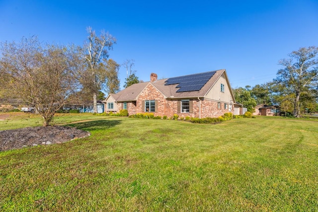 view of front of home with a front lawn and solar panels