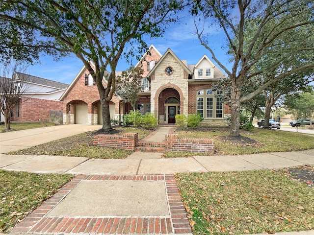 view of front of home featuring a garage and a front lawn