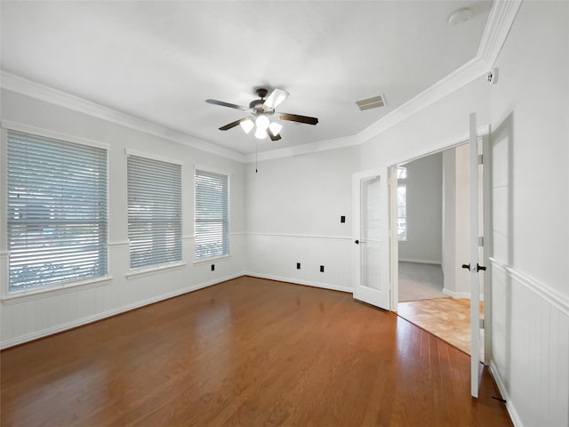 unfurnished room with hardwood / wood-style flooring, ornamental molding, french doors, and ceiling fan