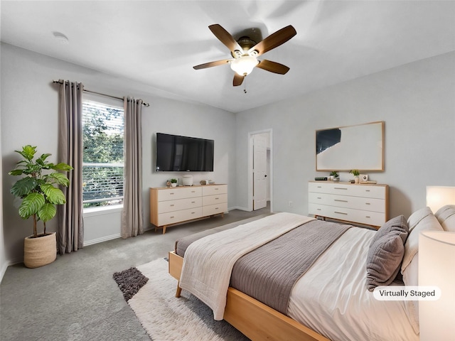 bedroom with ceiling fan and light carpet