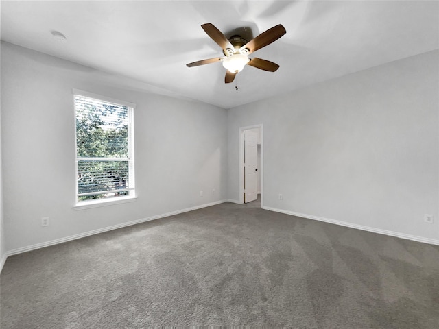 carpeted spare room featuring ceiling fan